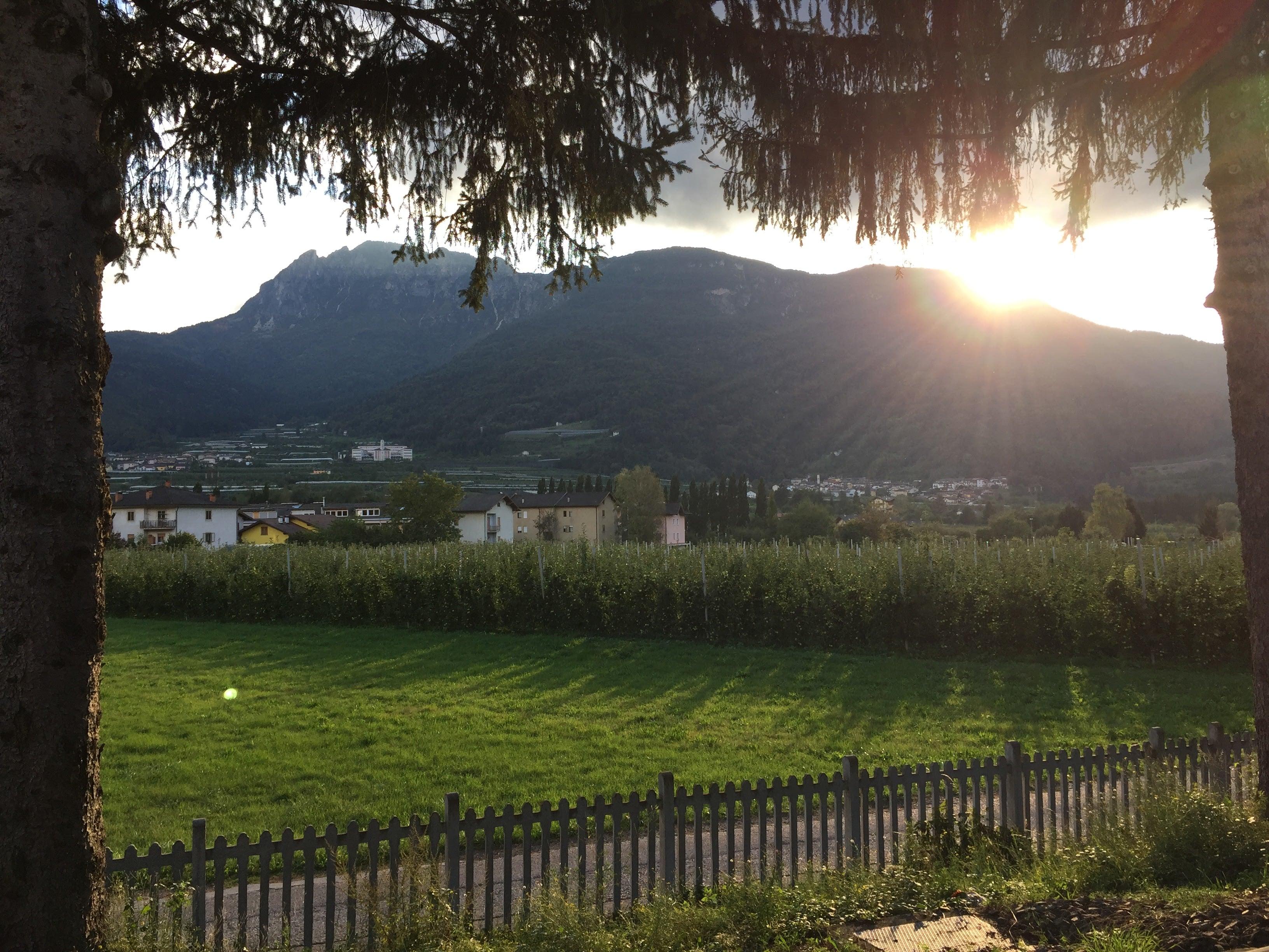 Sunset over an Italian valley with mountains and village houses