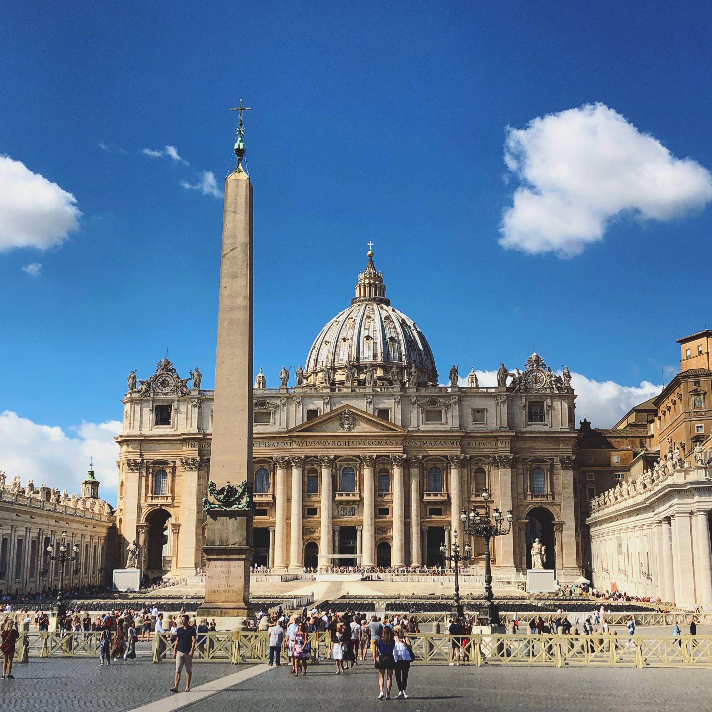 St Peters Basilica and obelisk in Vatican City under blue sky