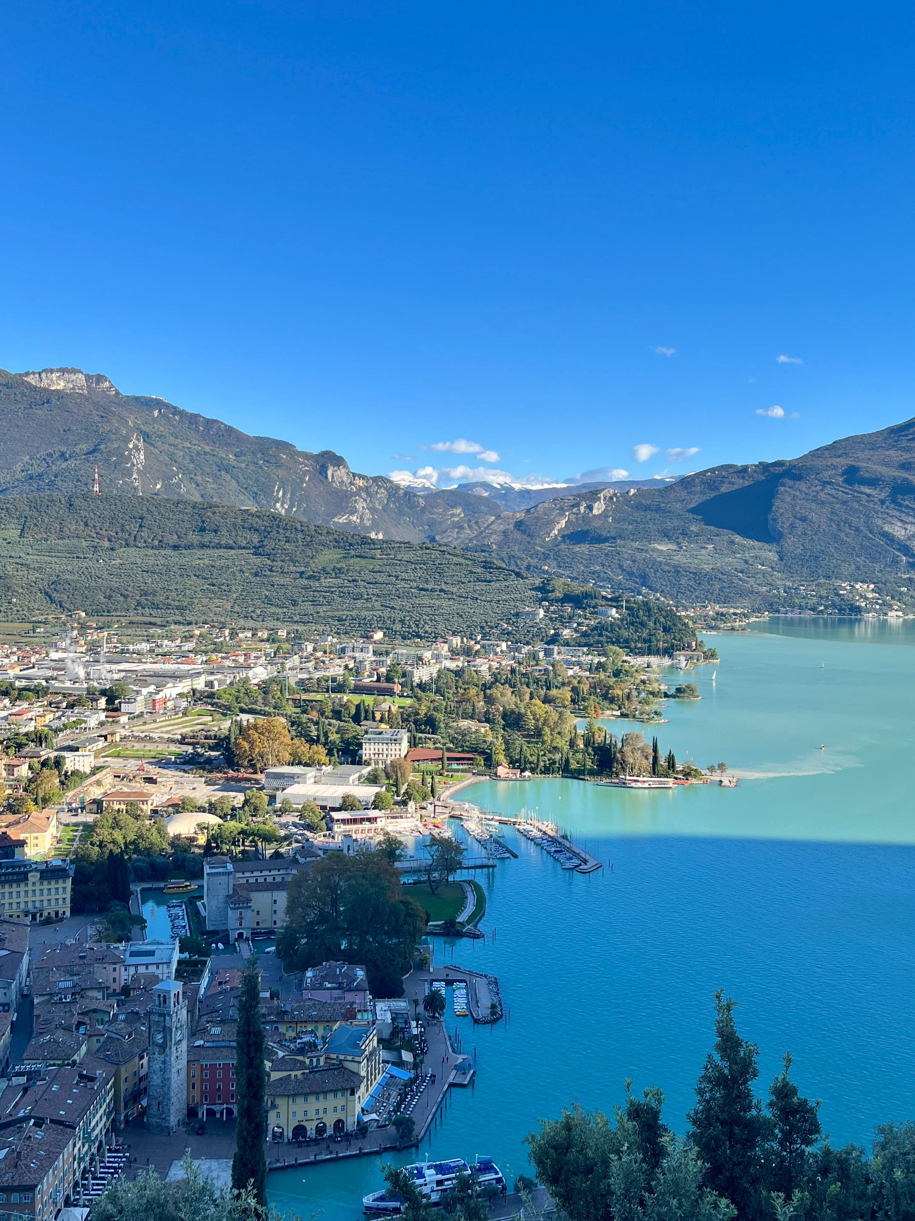 Turquoise waters of Lake Garda with town and mountains