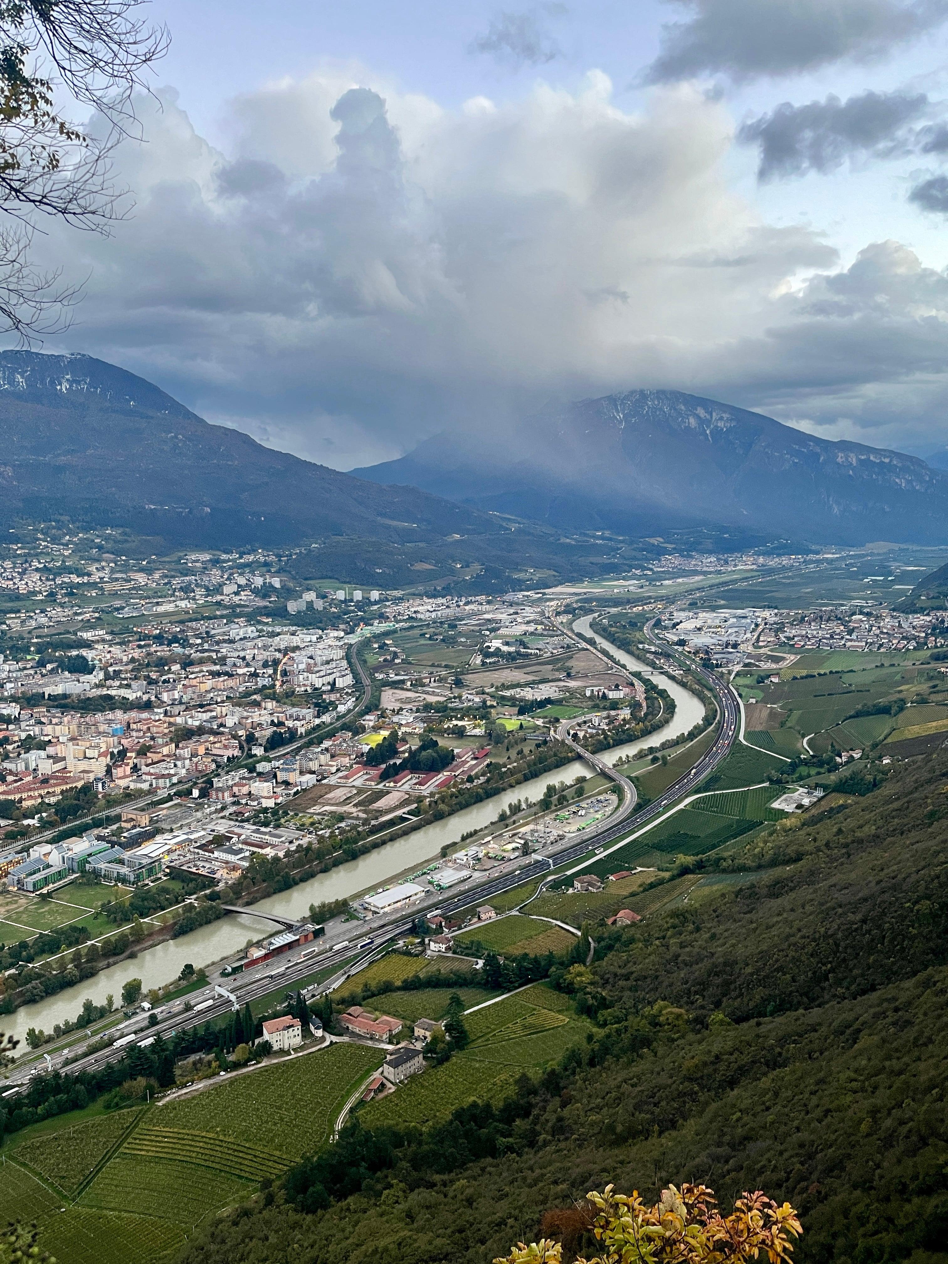 Aerial view of Trento valley with river and surrounding Alps