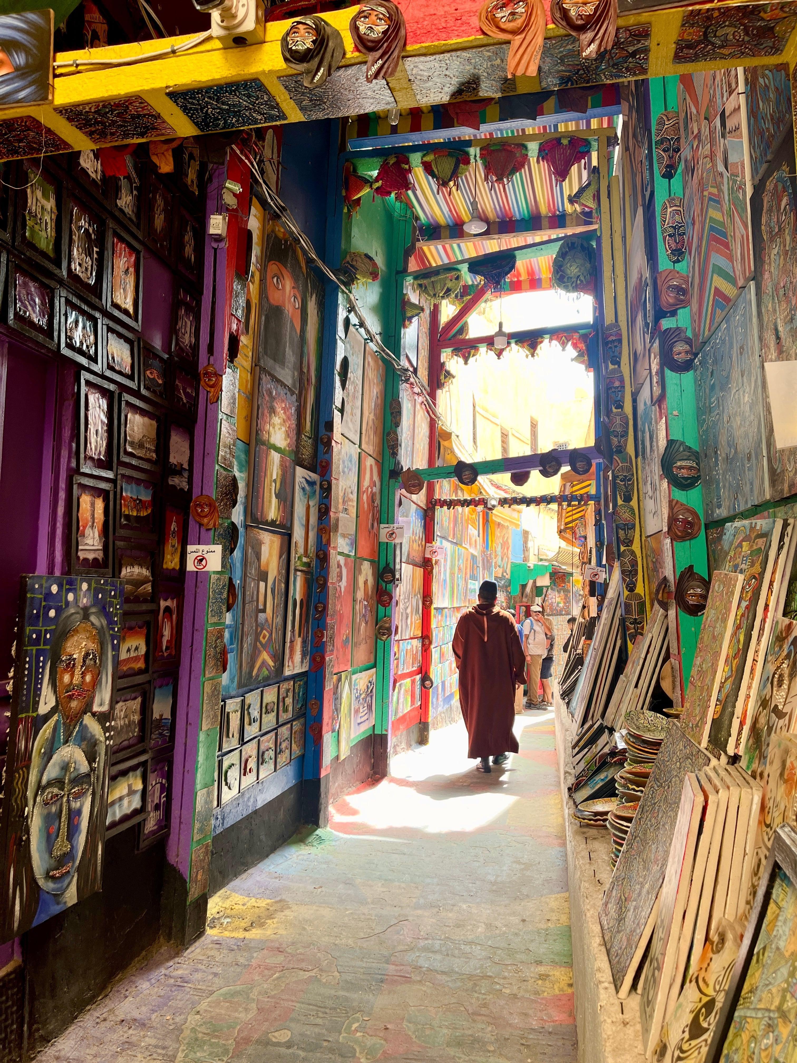 Colorful art-filled narrow alley in Fes medina
