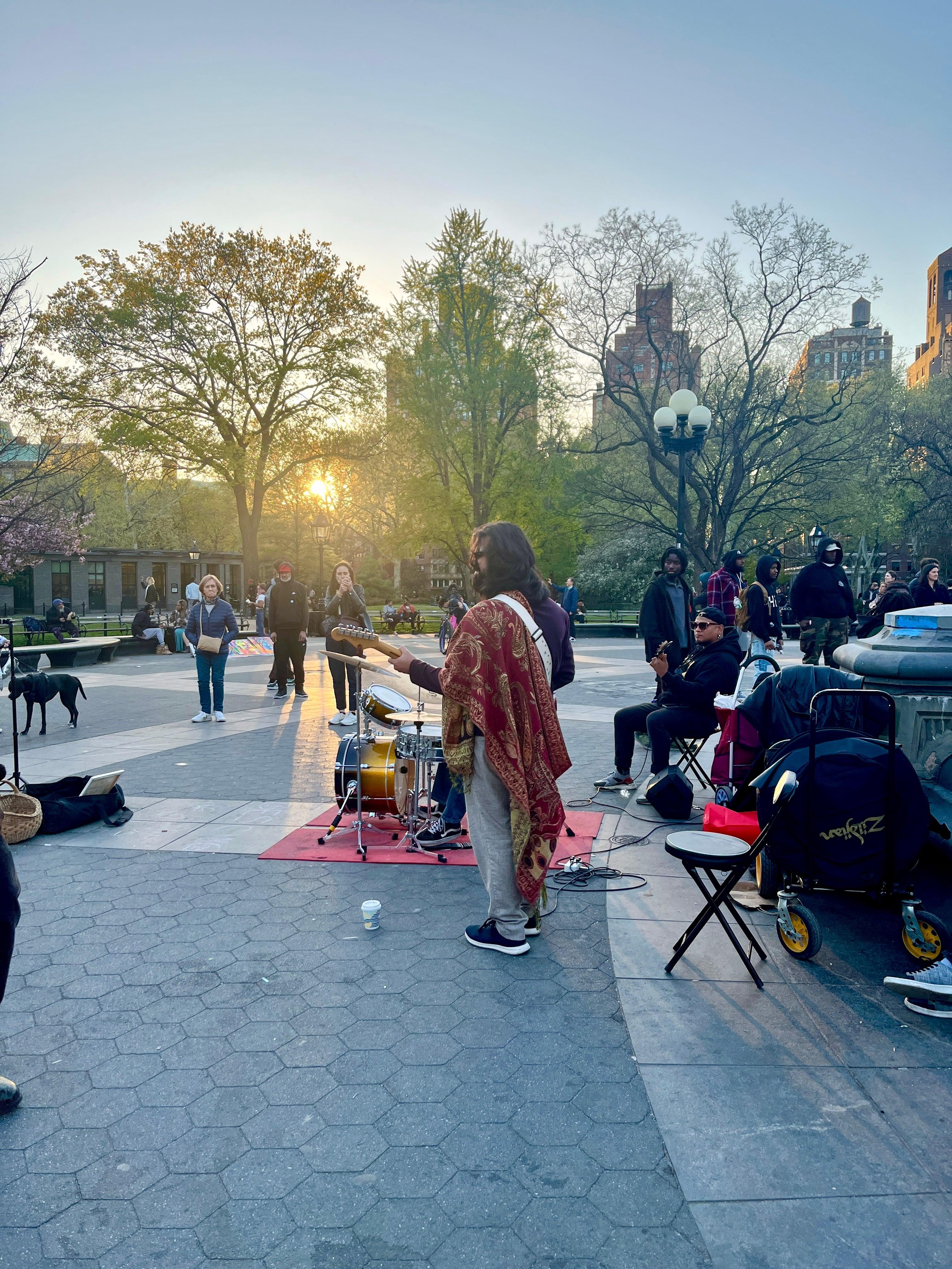 Street musician performing at sunset in Washington Square Park