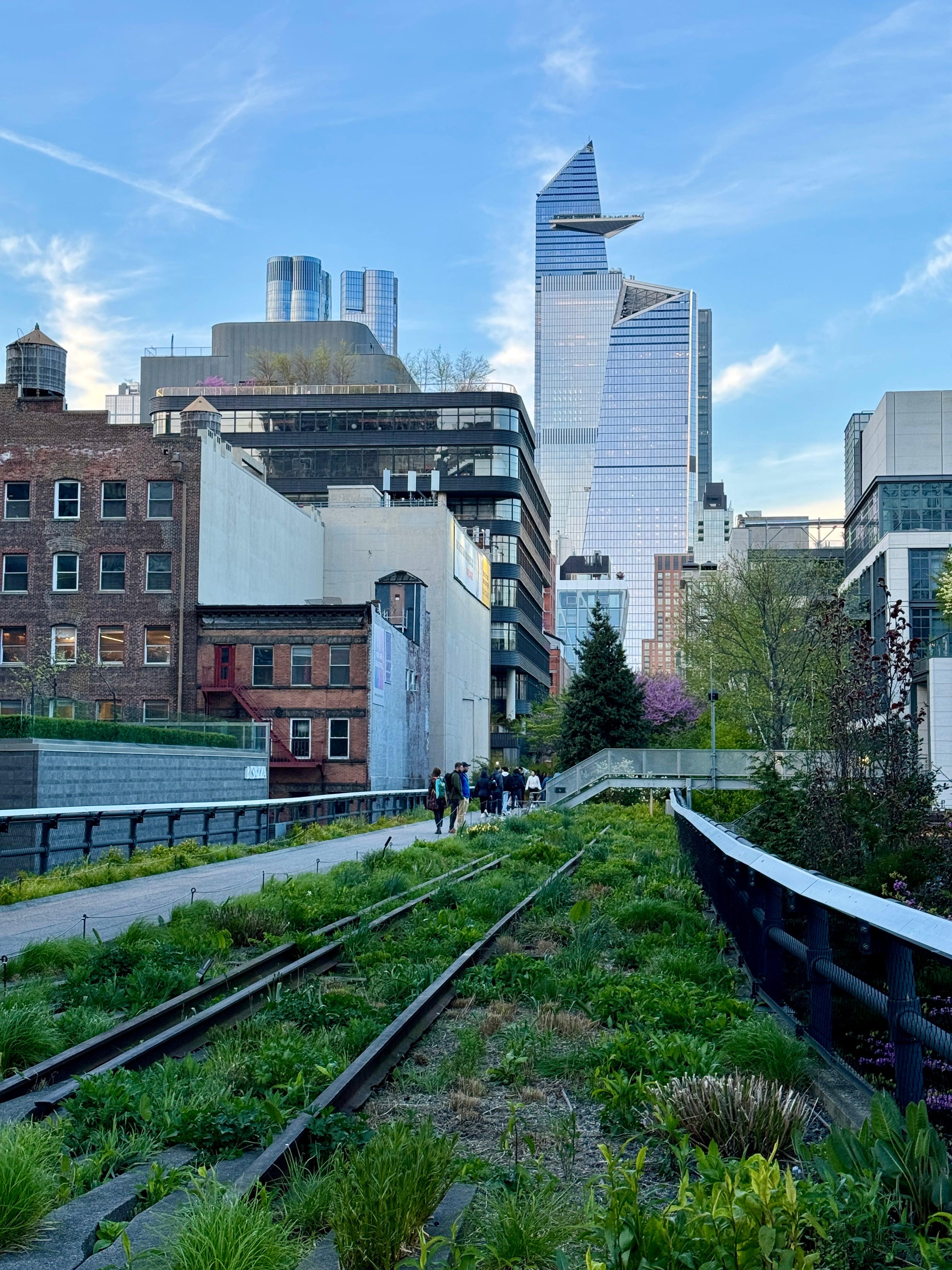 High Line park walkway with rail tracks and Hudson Yards skyline