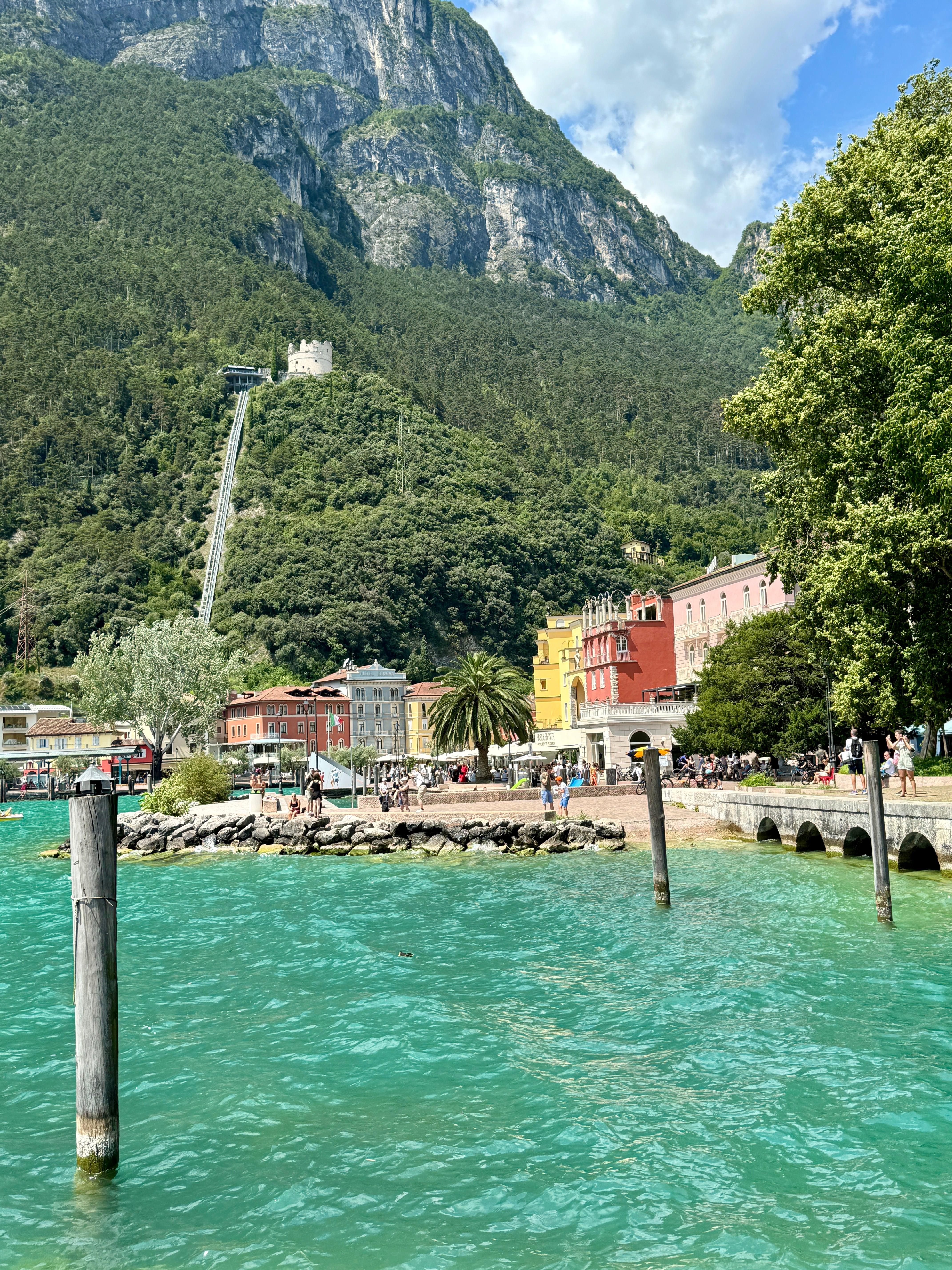 Turquoise Lake Garda waters with colorful town and mountains