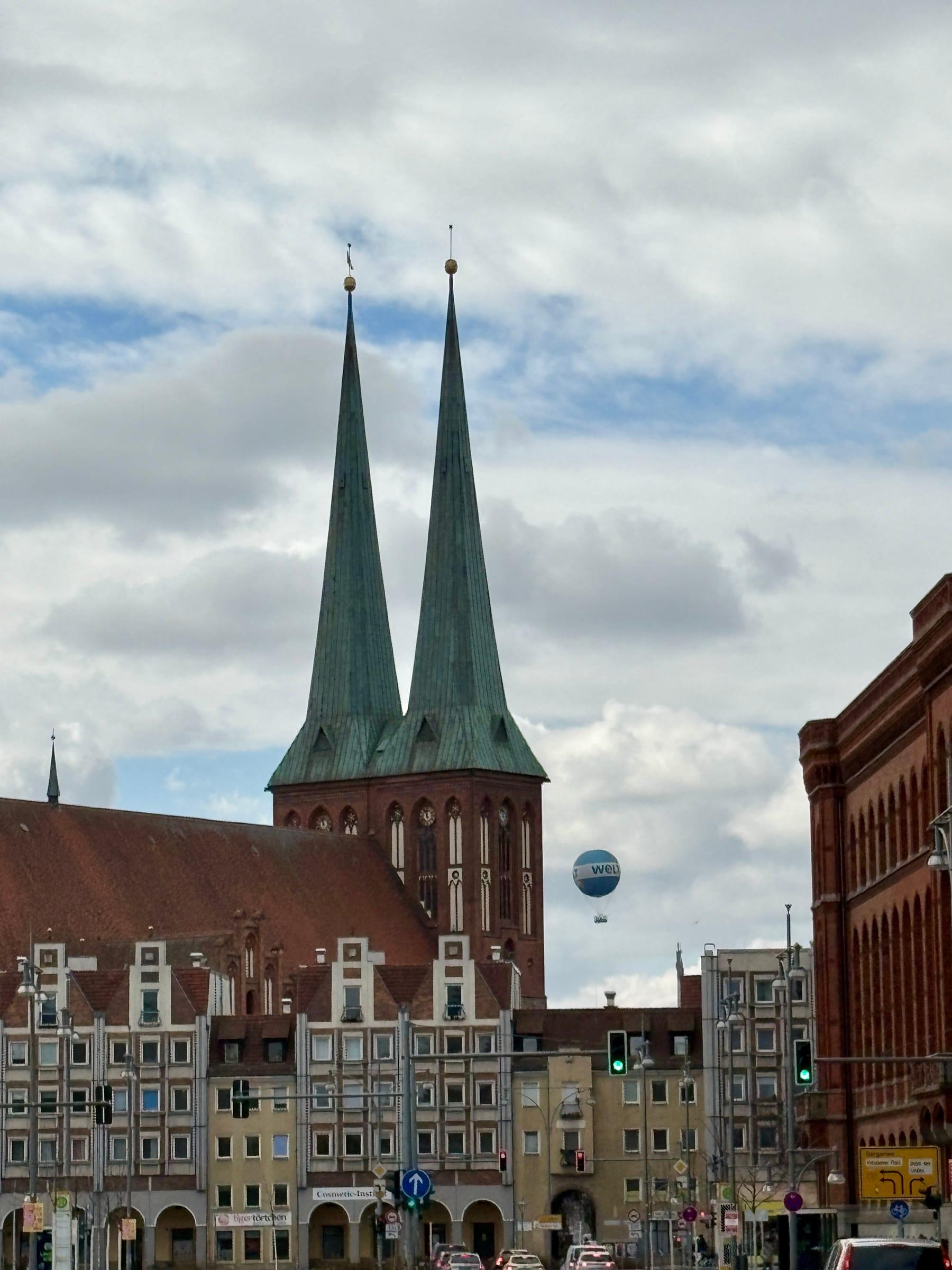 Nikolaikirche twin spires with Welt balloon in Berlin